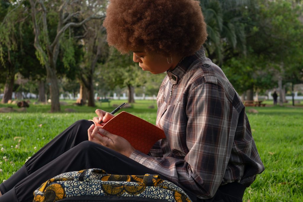 photo of woman writing on notebook 3061023